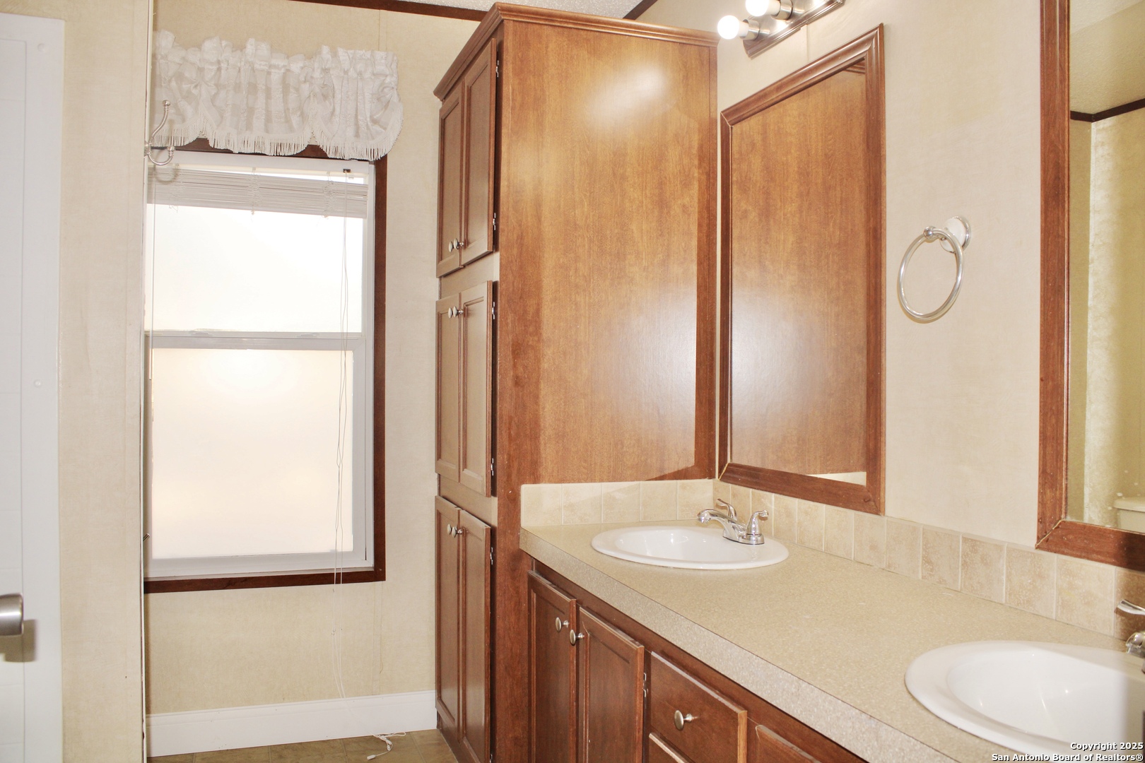 285 Rhonda Drive Lytle, TX 78052 - Photo 31 of 51 a bathroom with a sink and a mirror