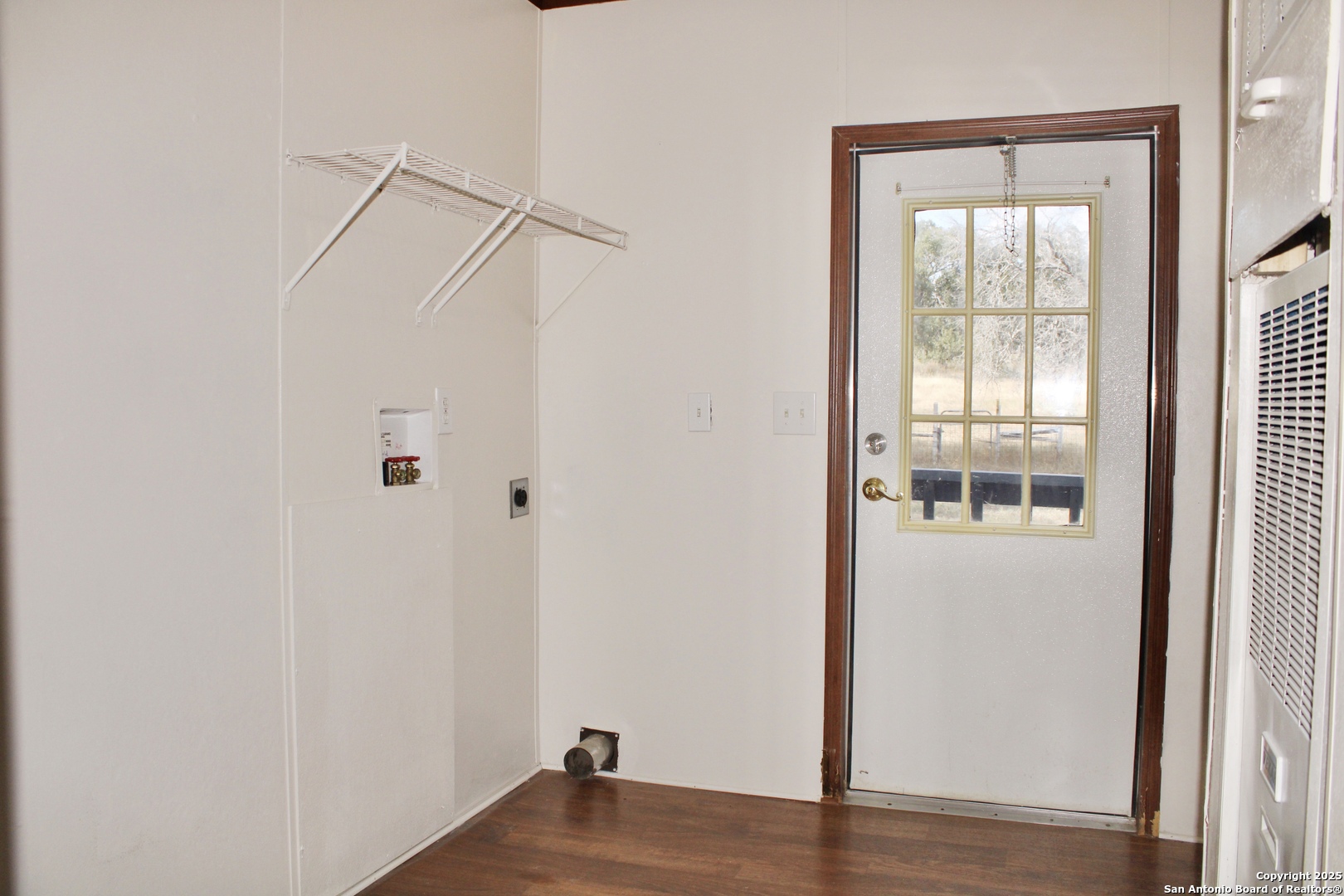 285 Rhonda Drive Lytle, TX 78052 - Photo 34 of 51 a view of a room with wooden floor and windows