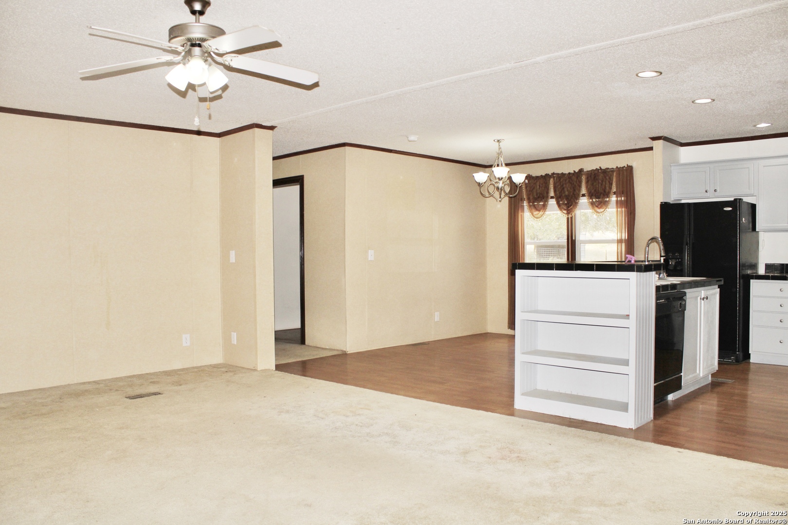 285 Rhonda Drive Lytle, TX 78052 - Photo 35 of 51 an empty room with chandelier fan and windows
