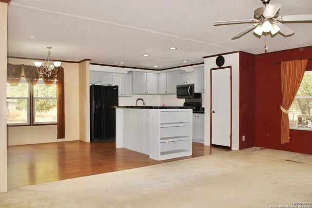 a view of kitchen with refrigerator and window