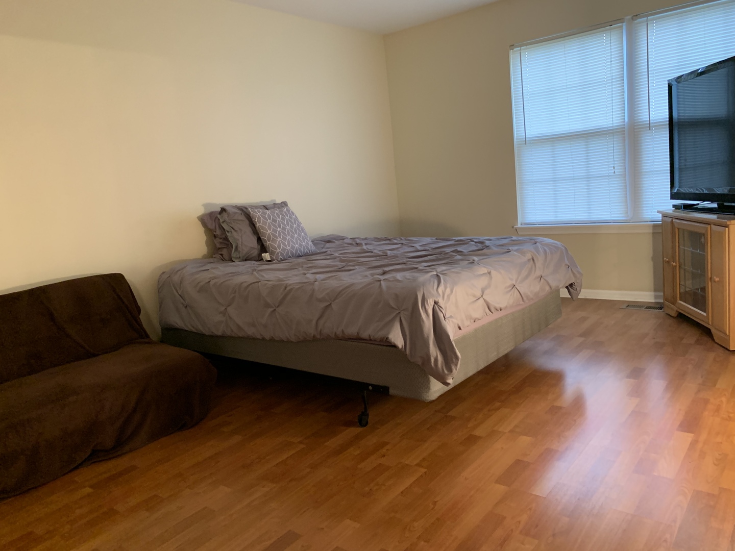 2927 Rutland Circle, Unit 101 Naperville, IL 60564 - Photo 6 of 11 a spacious bedroom with a bed and a flat screen tv