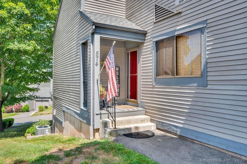 a view of a house with a yard and a garage