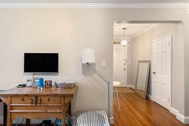 a view of a workspace with furniture and wooden floor