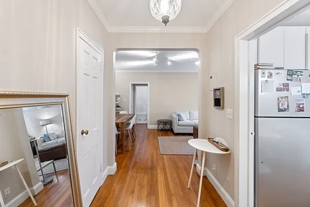 a view of living room with furniture and wooden floor