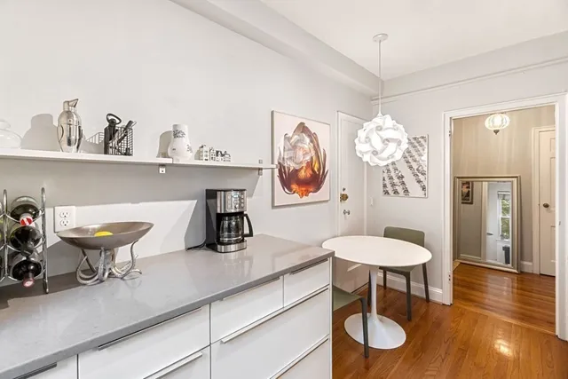 a kitchen with a sink cabinets and a table
