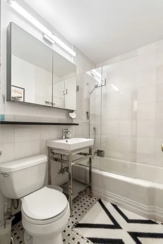 a bathroom with a sink a toilet and a bathtub