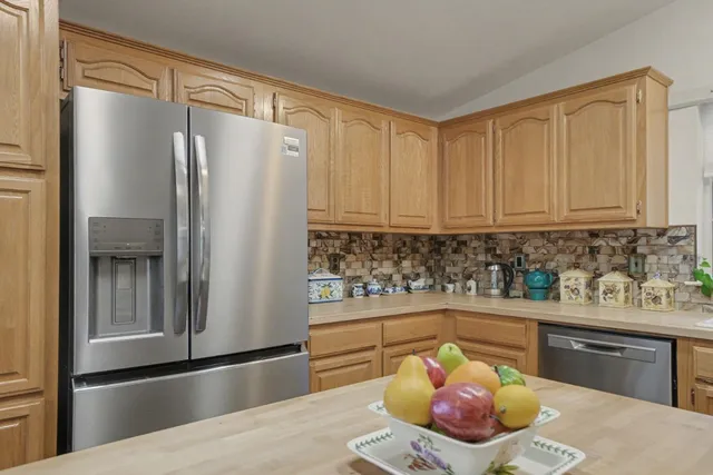 a kitchen with stainless steel appliances granite countertop a sink stove and cabinets