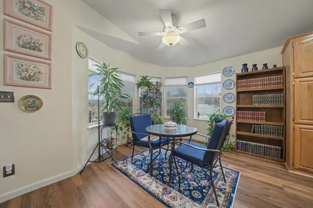 a view of a dining room with furniture and wooden floor