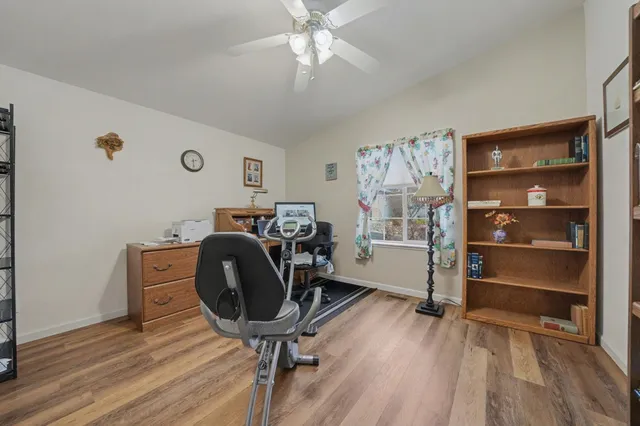 a view of a workspace with furniture and a window