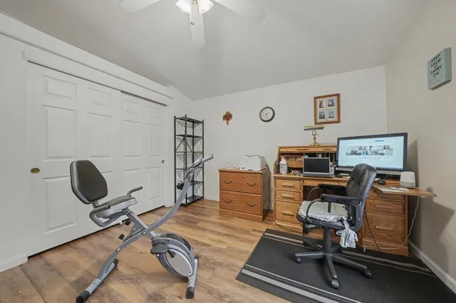 a view of a workspace with furniture and a window