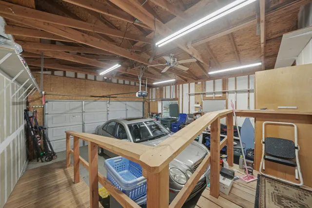 an aerial view of a house with a big yard and potted plants