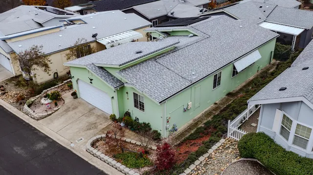 an aerial view of a house with a yard basket ball court