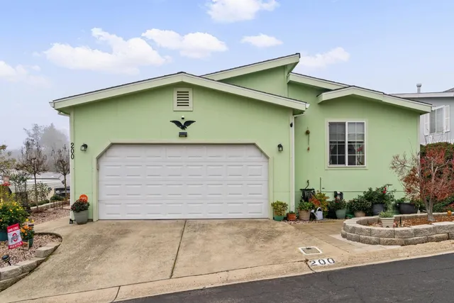a view of a house with a wooden deck