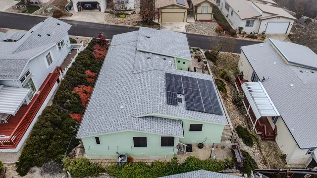 an aerial view of a house with a yard