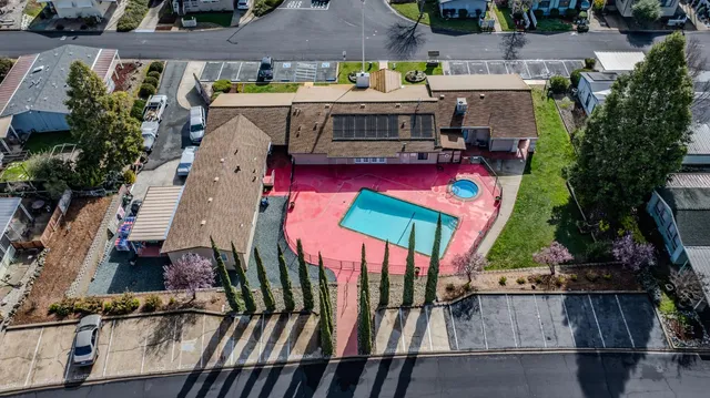 an aerial view of a house with yard swimming pool and outdoor seating
