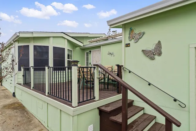 a living room with furniture dining table wooden floor and a fireplace