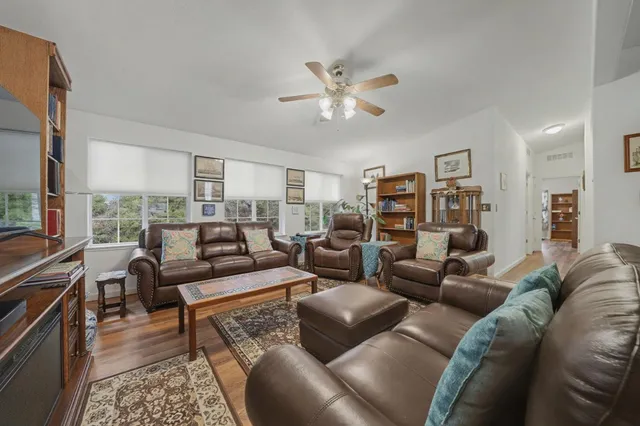 a living room with furniture a fireplace and a chandelier