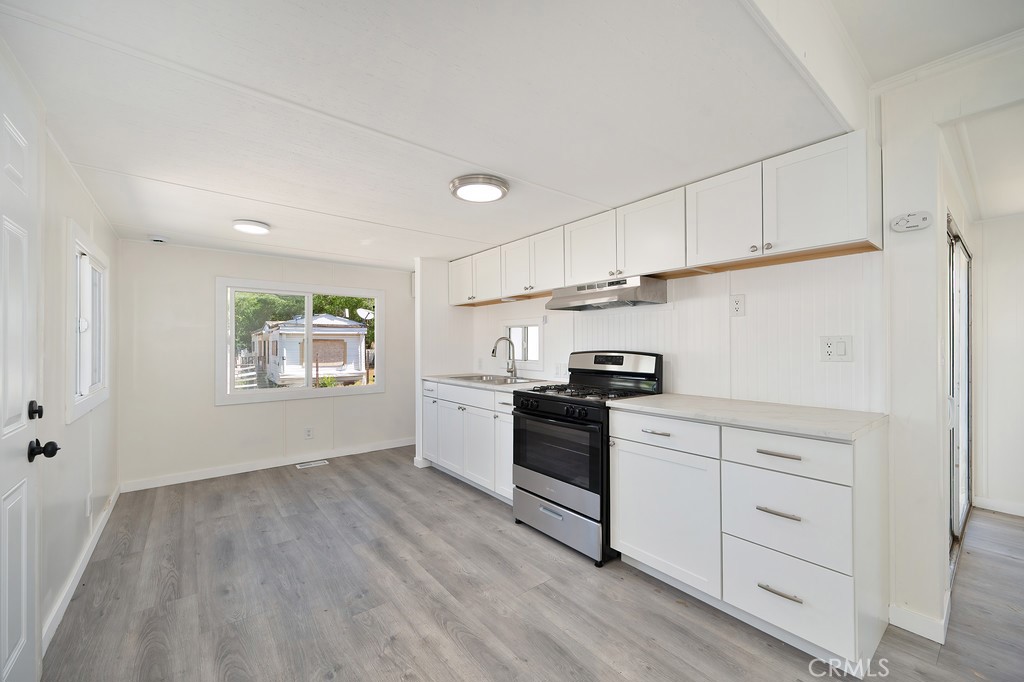 26455 Paradise Valley Road, Unit 86 Warner Springs, CA 92086 - Photo 14 of 34 a kitchen with white cabinets and appliances