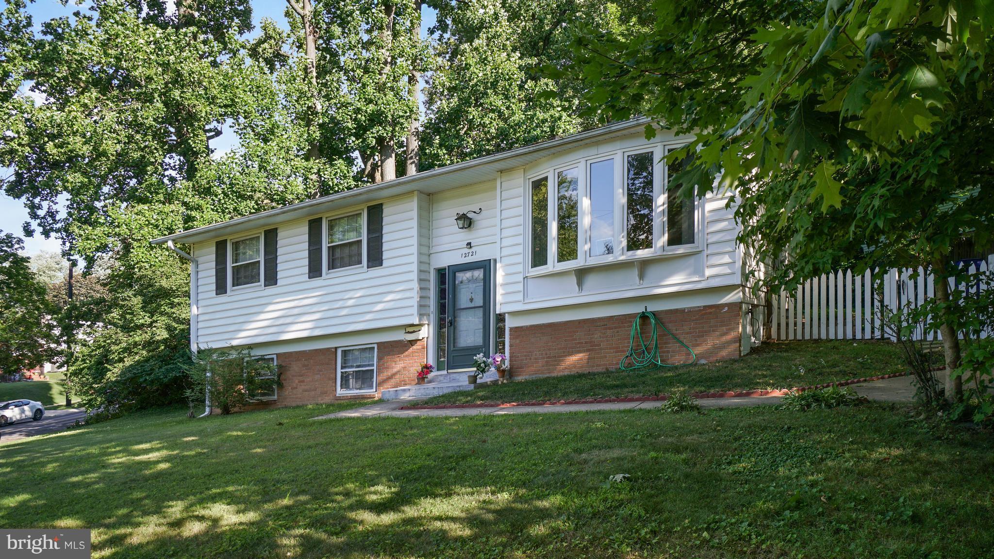 12721 Barbara Road Silver Spring, MD 20906 - Photo 3 of 30 a view of a yard in front of a house with plants and large tree