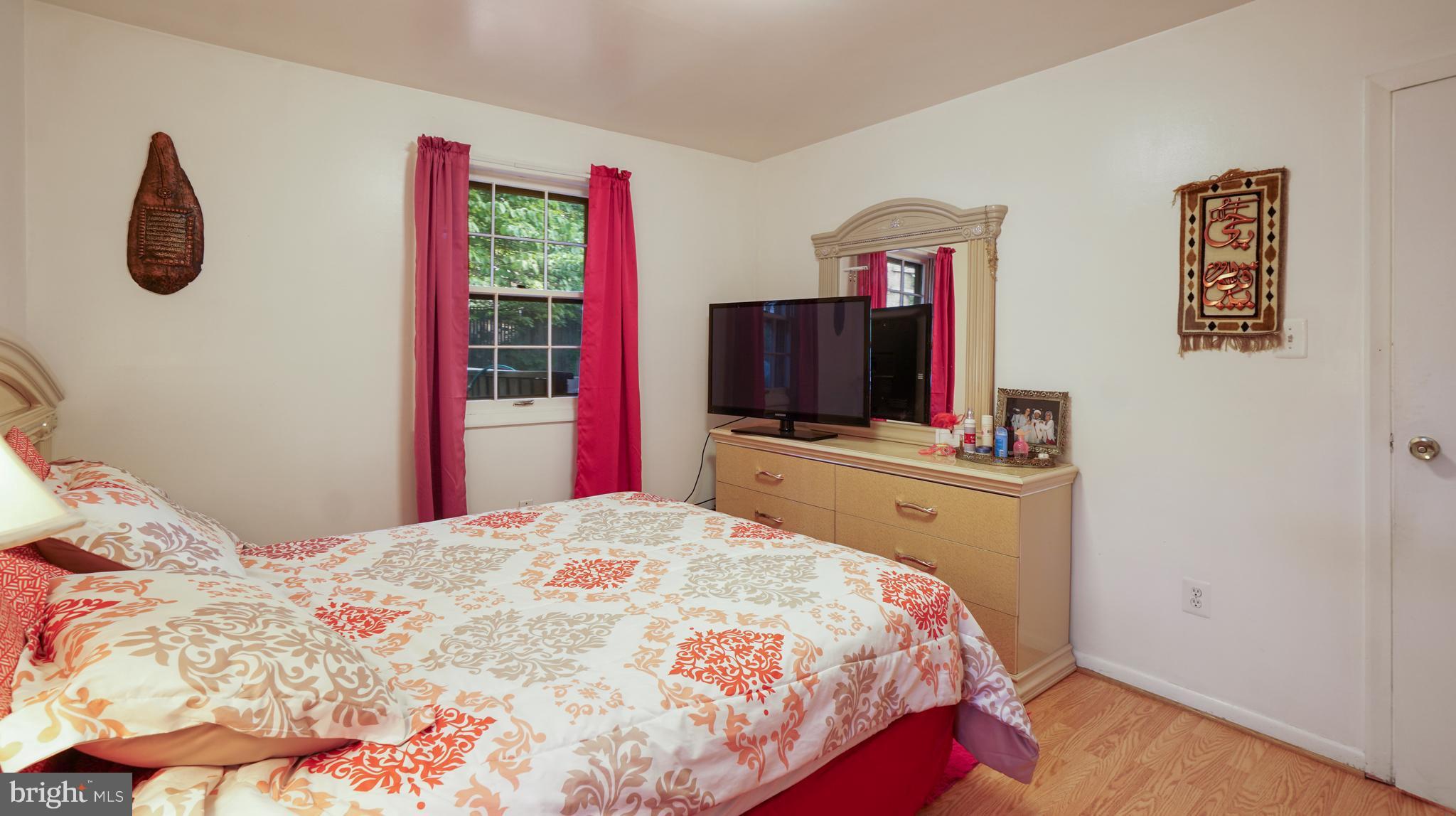 12721 Barbara Road Silver Spring, MD 20906 - Photo 22 of 30 a bedroom with a bed and a flat screen tv