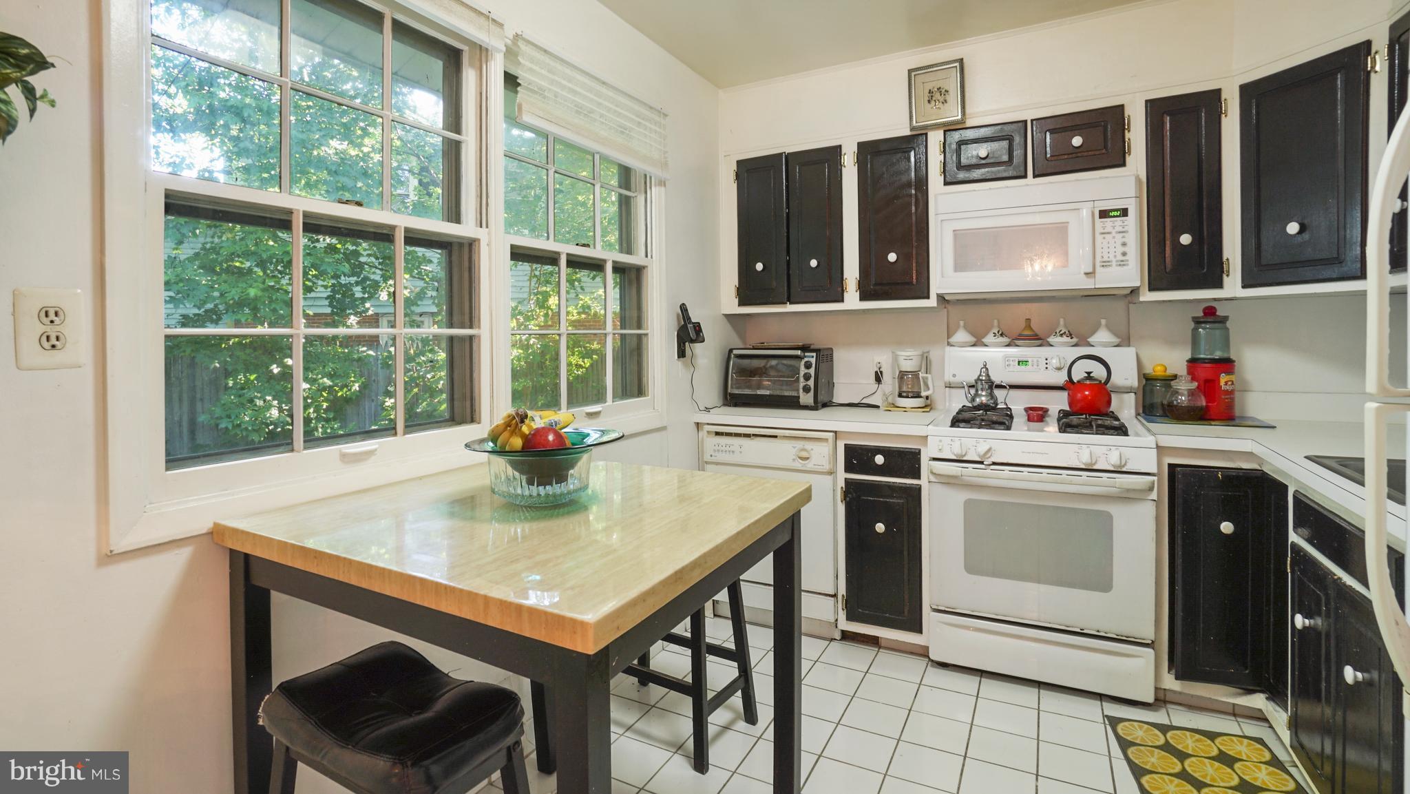 12721 Barbara Road Silver Spring, MD 20906 - Photo 9 of 30 a kitchen with a stove a sink and a microwave