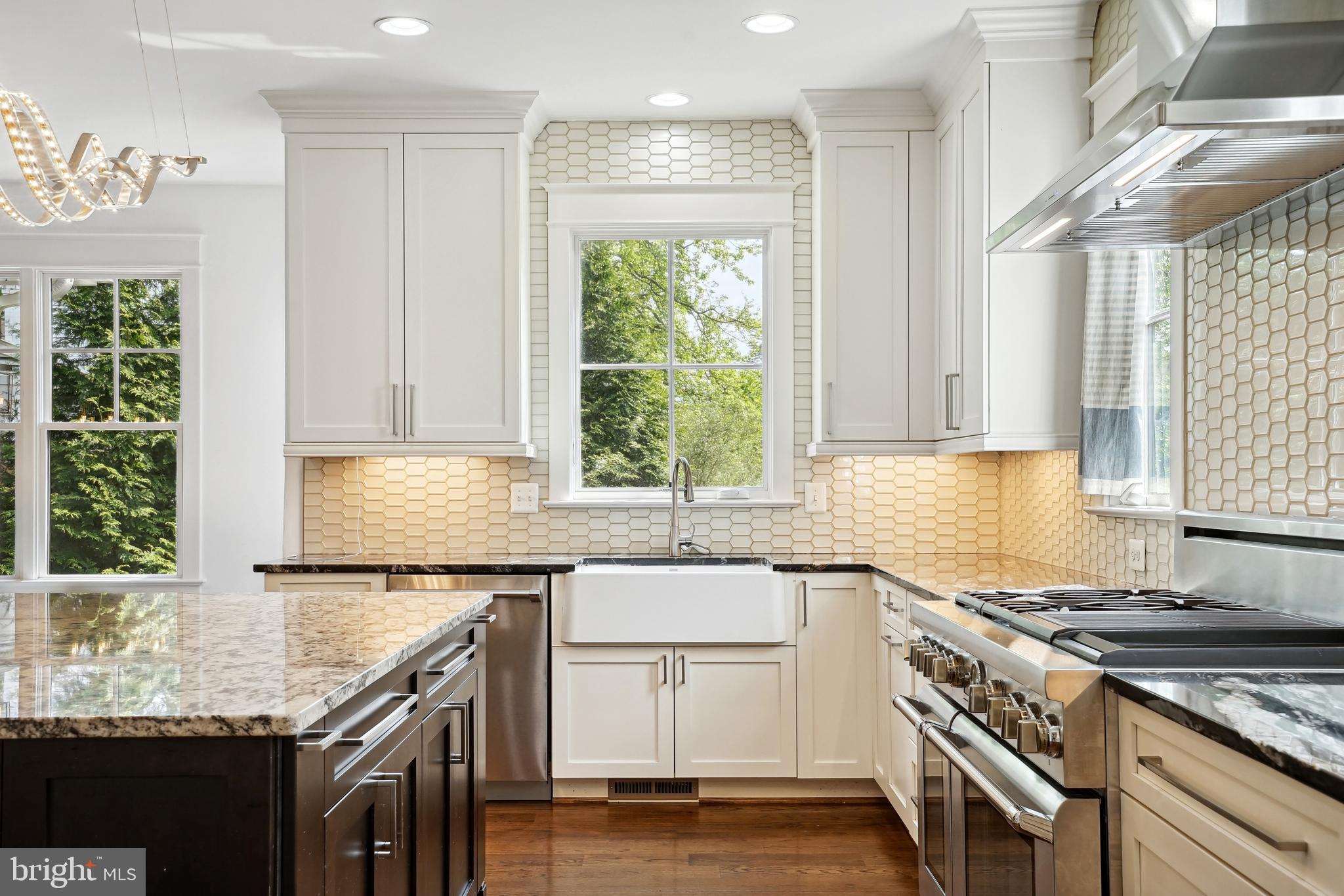 6719 Van Fleet Drive McLean, VA 22101 - Photo 12 of 29 a kitchen with granite countertop a sink a counter space and stainless steel appliances