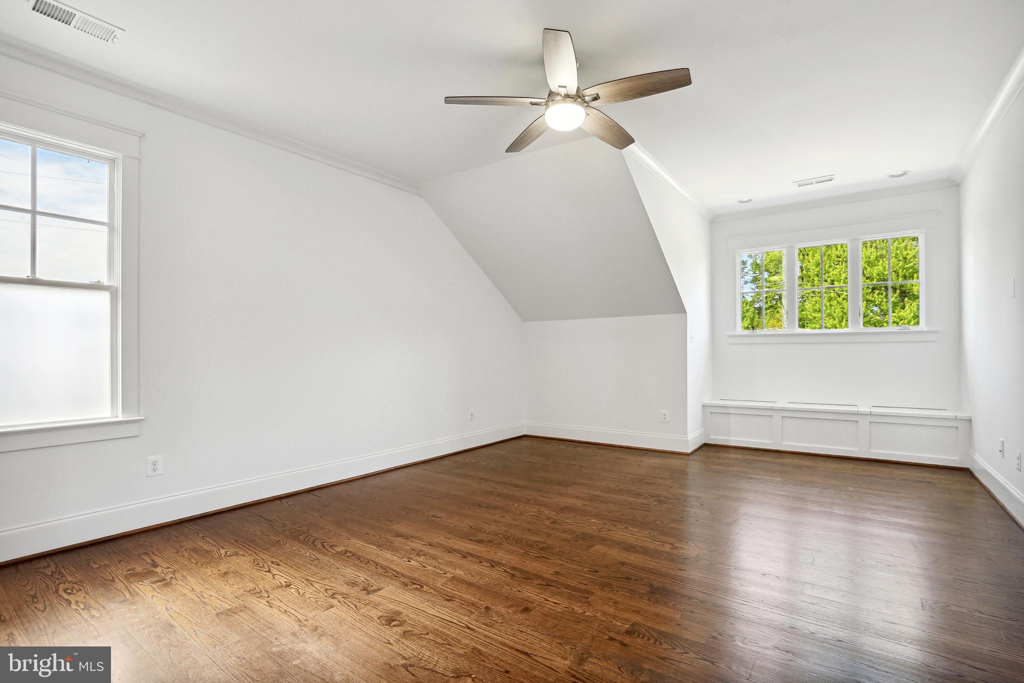 6719 Van Fleet Drive McLean, VA 22101 - Photo 19 of 29 an empty room with wooden floor fan and windows