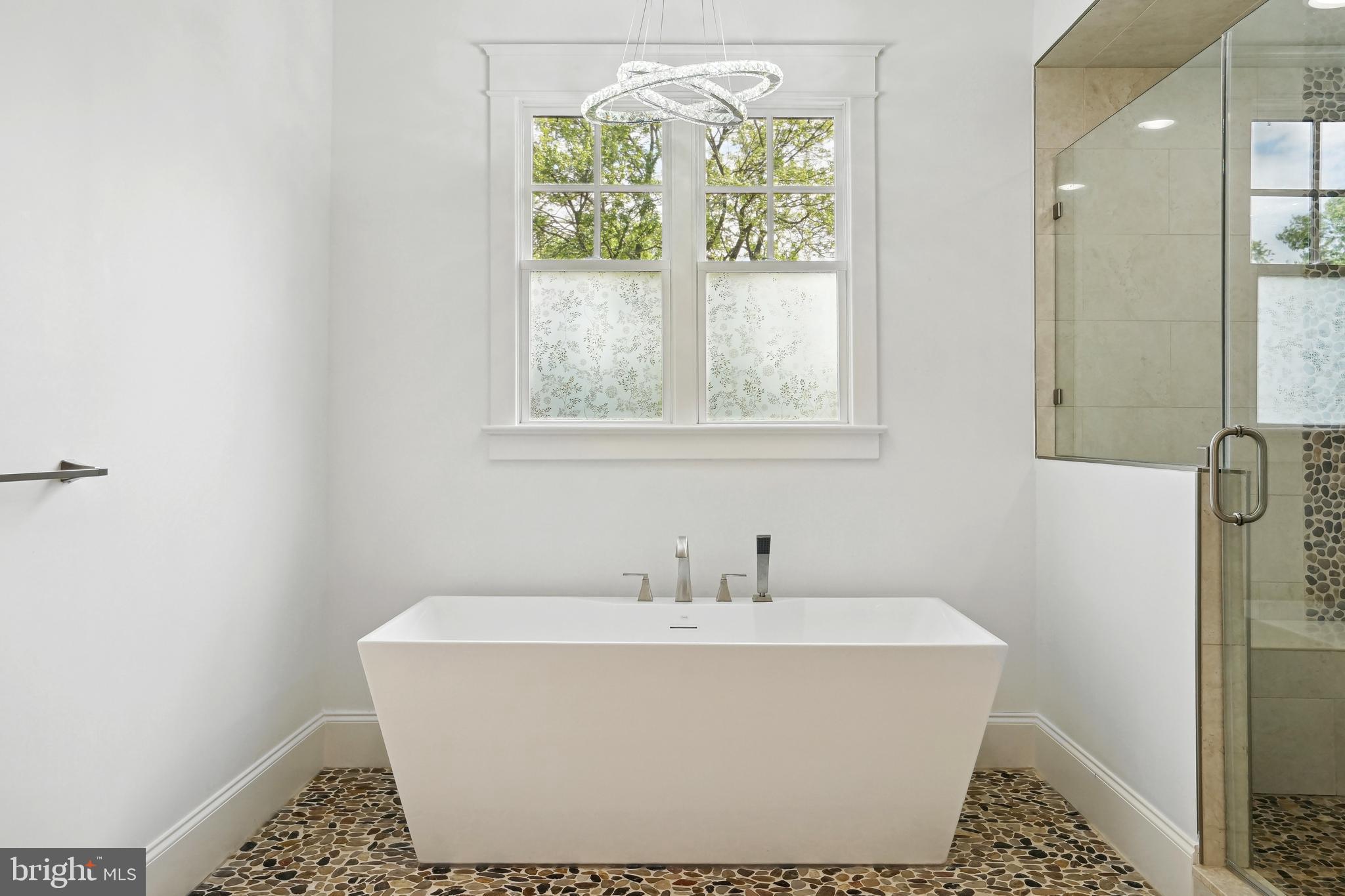 6719 Van Fleet Drive McLean, VA 22101 - Photo 20 of 29 a white bath tub sitting in a bathroom next to a window