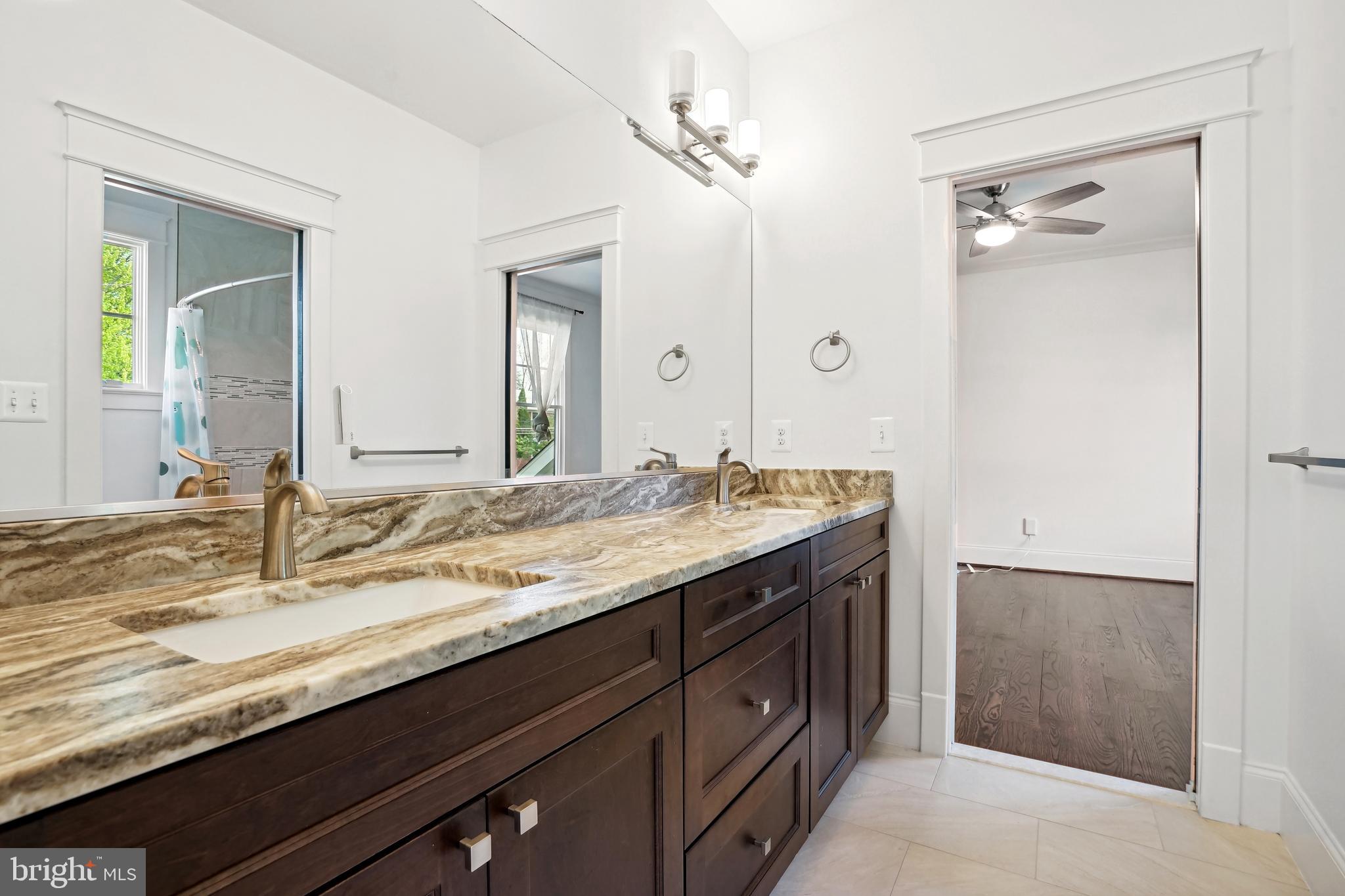 6719 Van Fleet Drive McLean, VA 22101 - Photo 22 of 29 a bathroom with a granite countertop sink and a mirror