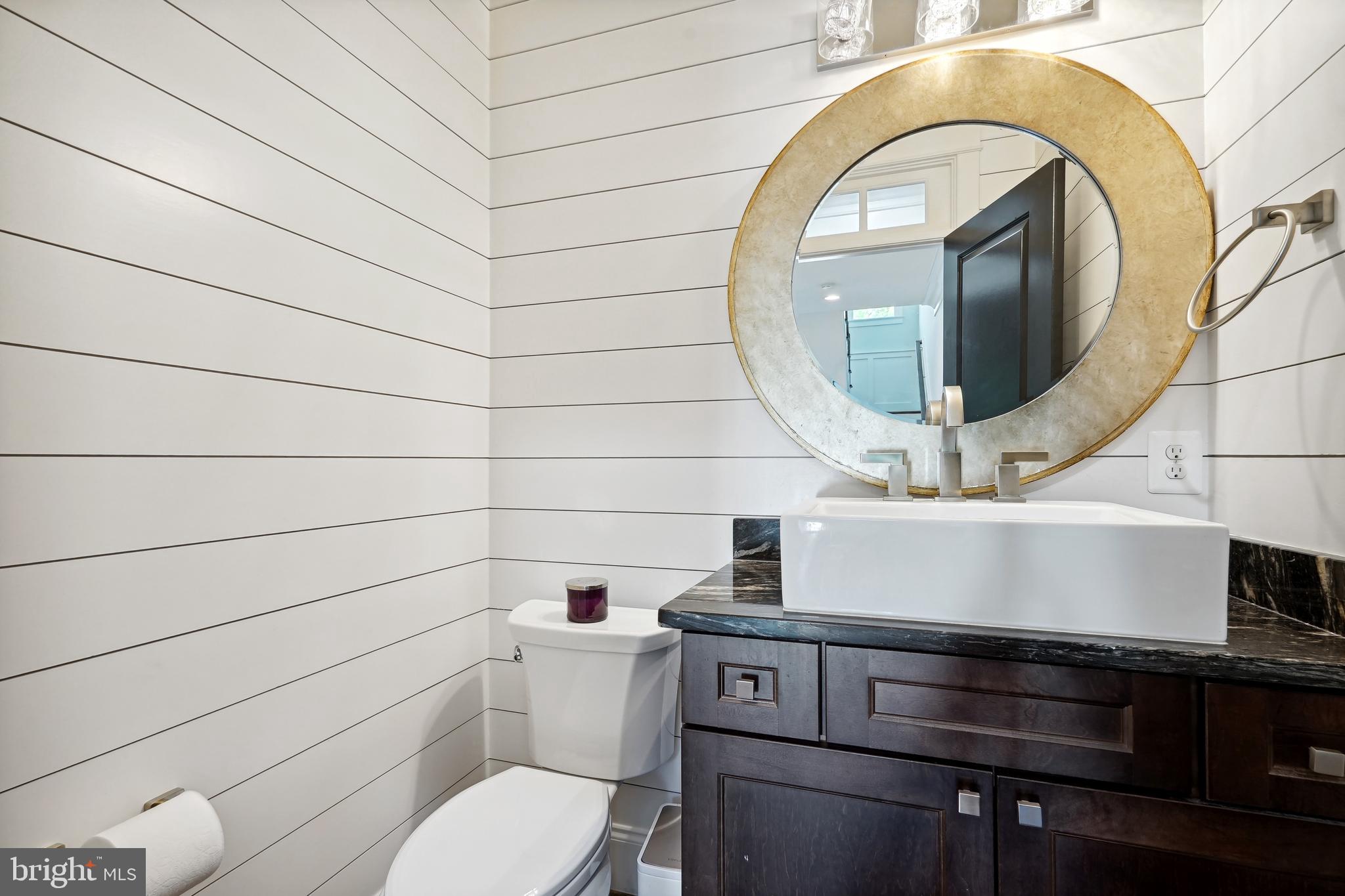 6719 Van Fleet Drive McLean, VA 22101 - Photo 26 of 29 a bathroom with a toilet a sink and mirror