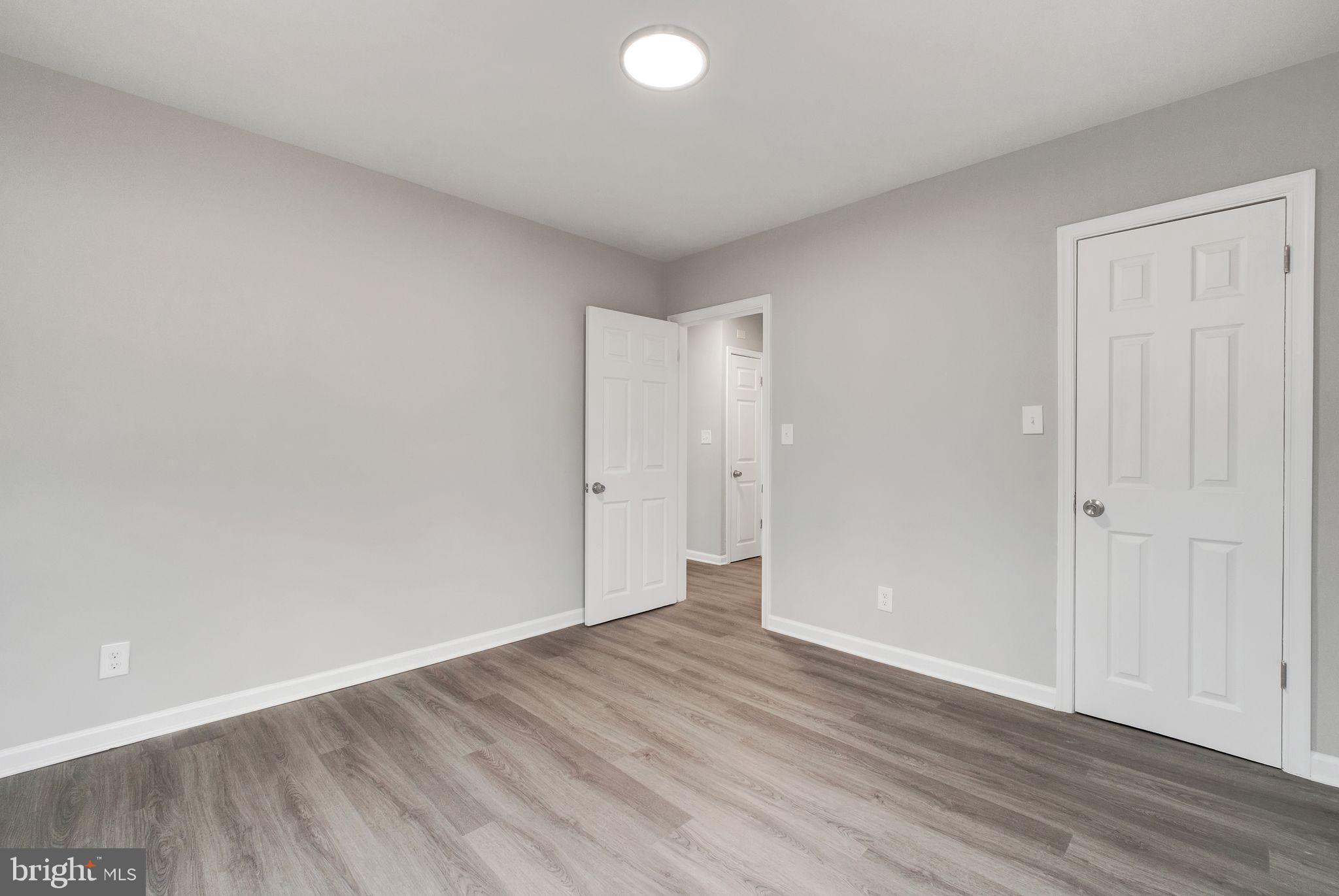 4829 Gilray Drive Baltimore, MD 21214 - Photo 12 of 28 a view of an empty room with wooden floor and closet