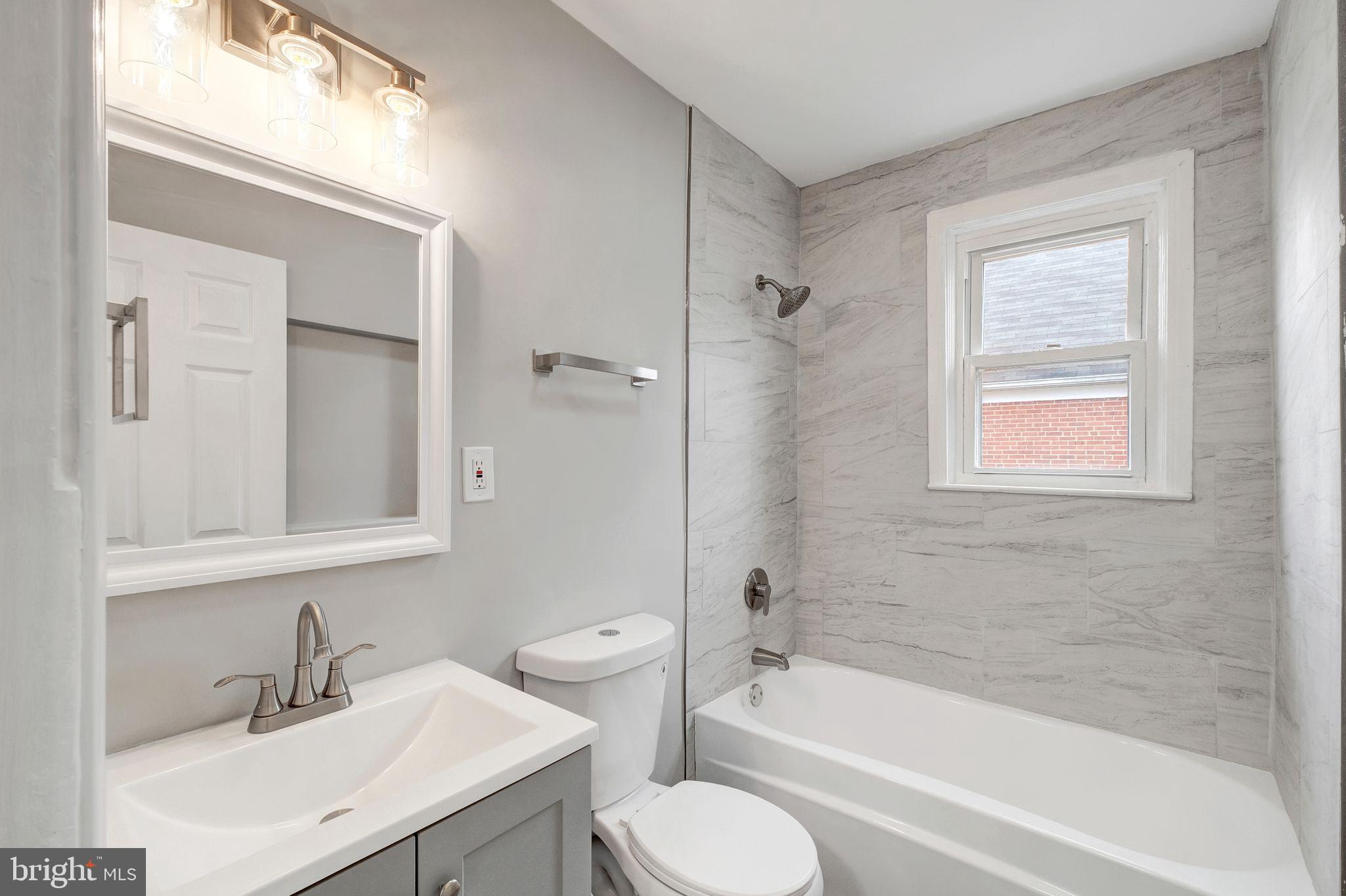 4829 Gilray Drive Baltimore, MD 21214 - Photo 13 of 28 a bathroom with a sink toilet and shower