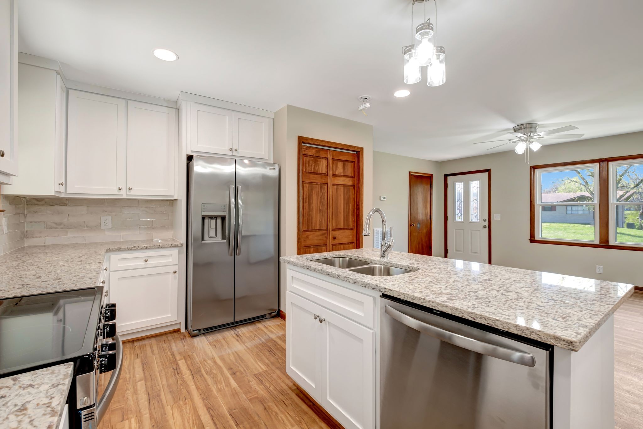 5010 Bonnameade Drive Hermitage, TN 37076 - Photo 12 of 27 a kitchen with stainless steel appliances granite countertop a sink stove and refrigerator