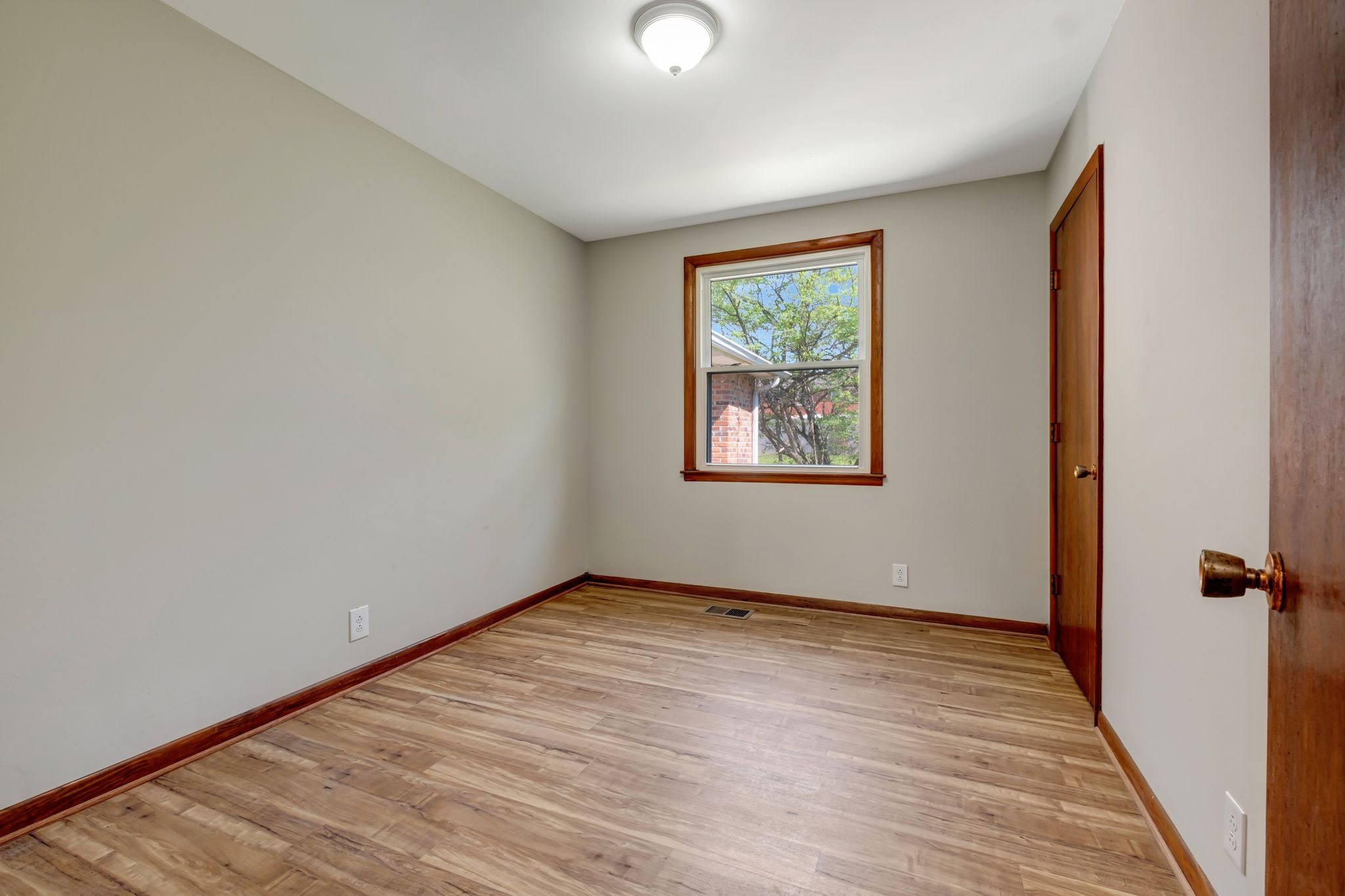 5010 Bonnameade Drive Hermitage, TN 37076 - Photo 18 of 27 a view of an empty room with wooden floor and a window