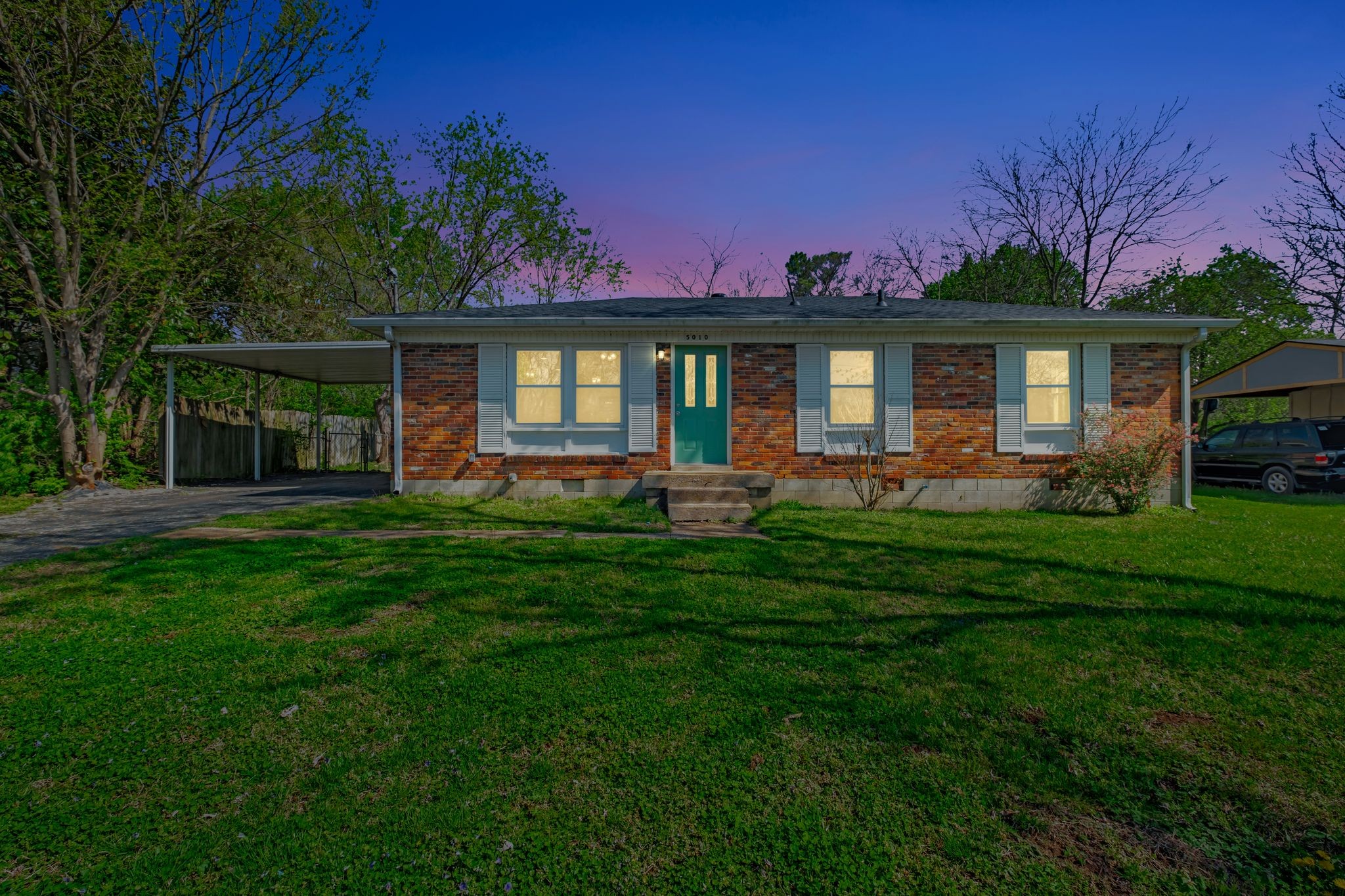 5010 Bonnameade Drive Hermitage, TN 37076 - Photo 3 of 27 a front view of a house with a garden and yard