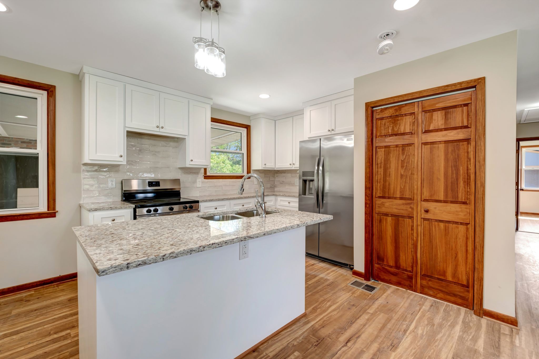5010 Bonnameade Drive Hermitage, TN 37076 - Photo 10 of 27 a kitchen with stainless steel appliances granite countertop a refrigerator a sink dishwasher a stove with wooden cabinets and floor