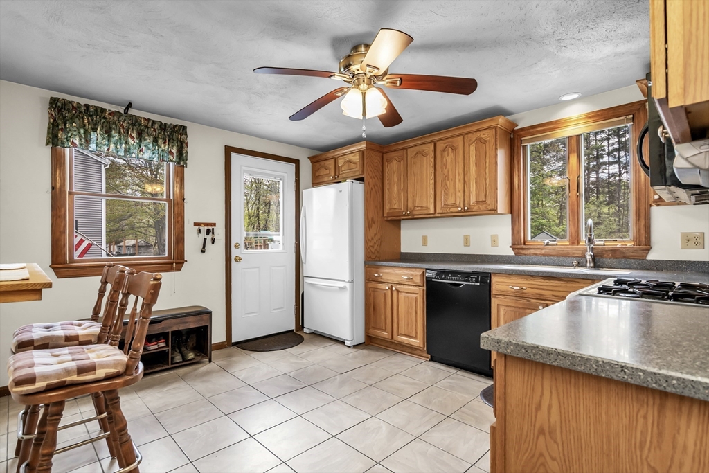 8 Portsmouth Road Amesbury, MA 01913 - Photo 11 of 37 a kitchen with a stove a sink and a refrigerator
