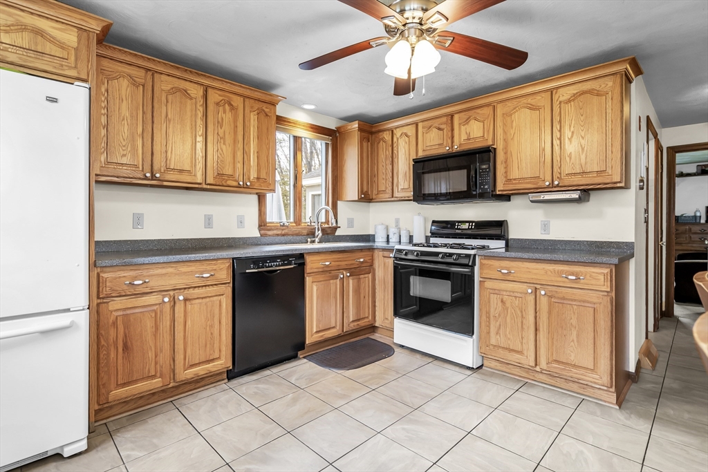 8 Portsmouth Road Amesbury, MA 01913 - Photo 12 of 37 a kitchen with stainless steel appliances granite countertop a stove top oven a sink dishwasher and a microwave oven on the blue kitchen countertops