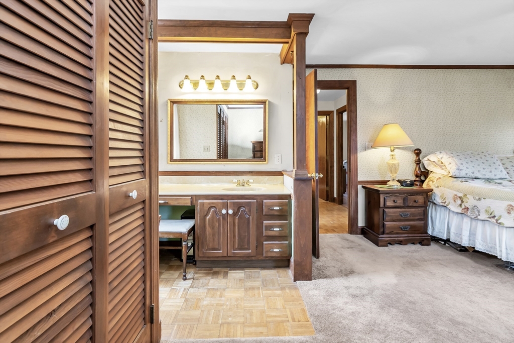 8 Portsmouth Road Amesbury, MA 01913 - Photo 15 of 37 a view of a bedroom with furniture and chandelier