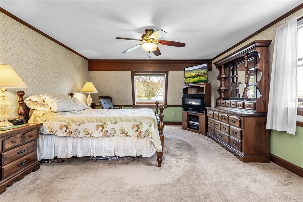 8 Portsmouth Road Amesbury, MA 01913 - Photo 18 of 37 a spacious bedroom with a bed a dresser and windows