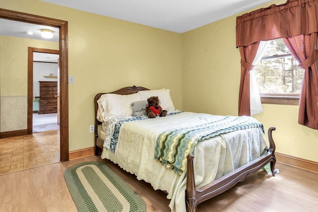 8 Portsmouth Road Amesbury, MA 01913 - Photo 26 of 37 a bedroom with a bed and wooden floor