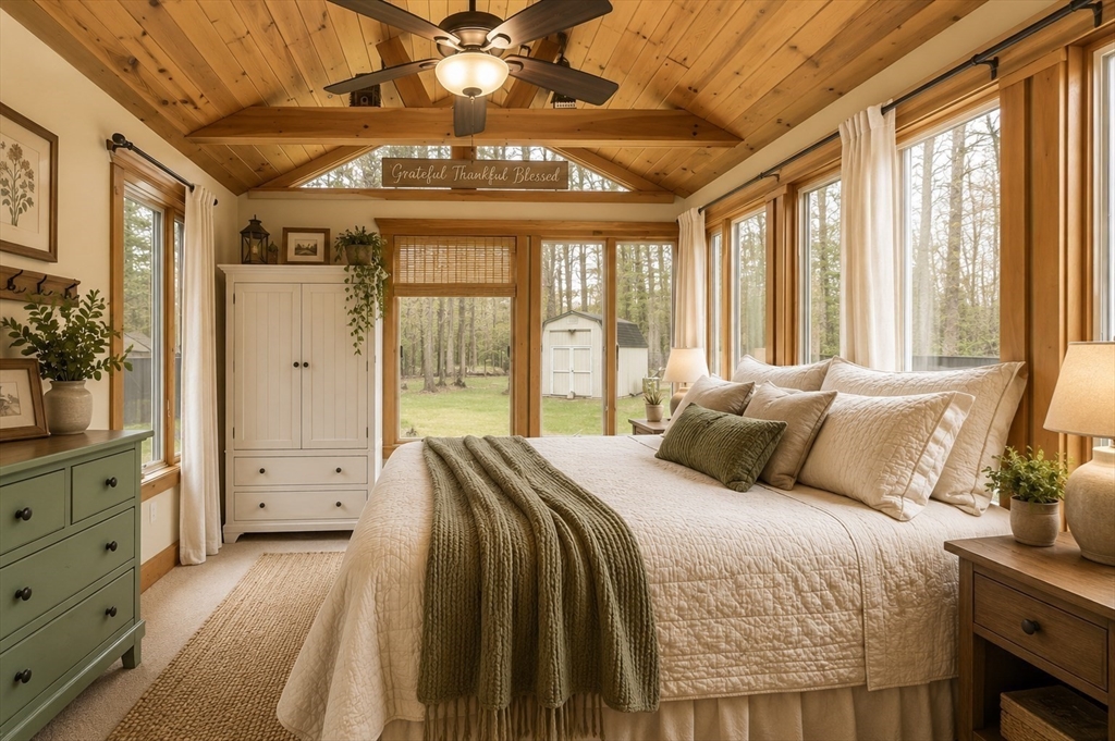 8 Portsmouth Road Amesbury, MA 01913 - Photo 28 of 37 a spacious bedroom with a large bed and a chandelier