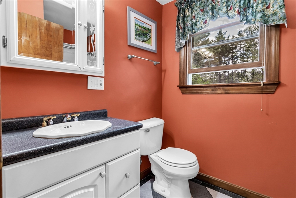 8 Portsmouth Road Amesbury, MA 01913 - Photo 29 of 37 a bathroom with a toilet sink and mirror