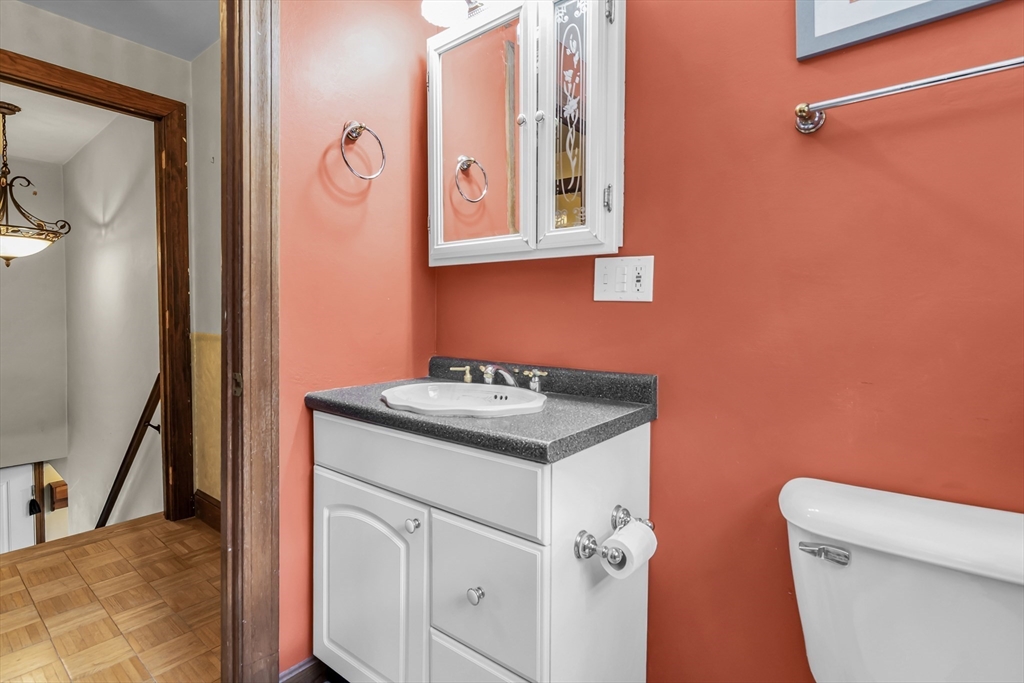 8 Portsmouth Road Amesbury, MA 01913 - Photo 30 of 37 a bathroom with a granite countertop sink a toilet and a mirror