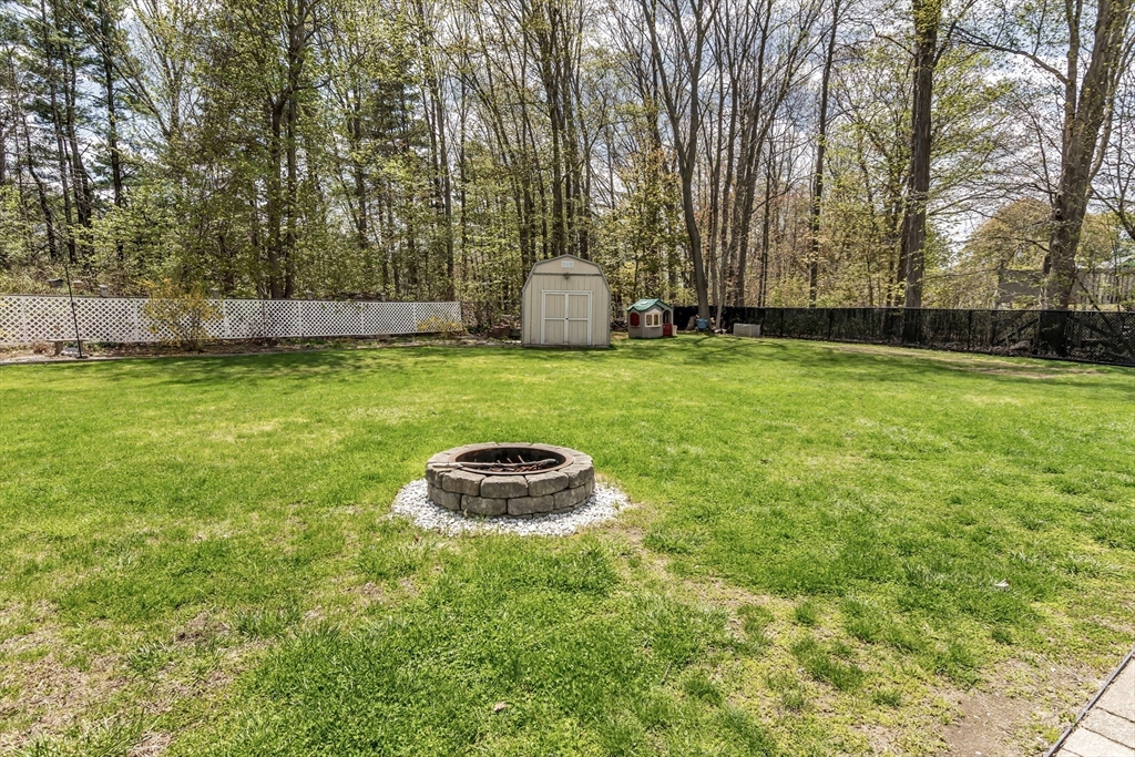 8 Portsmouth Road Amesbury, MA 01913 - Photo 35 of 37 a backyard of a house with lots of green space and garden view