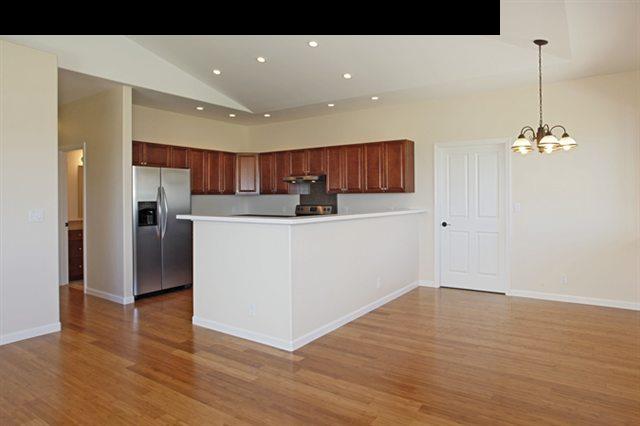 15 Maha Road, Unit 12 Makawao, HI 96768 - Photo 3 of 10 a view of kitchen with stainless steel appliances granite countertop refrigerator sink and wooden floor