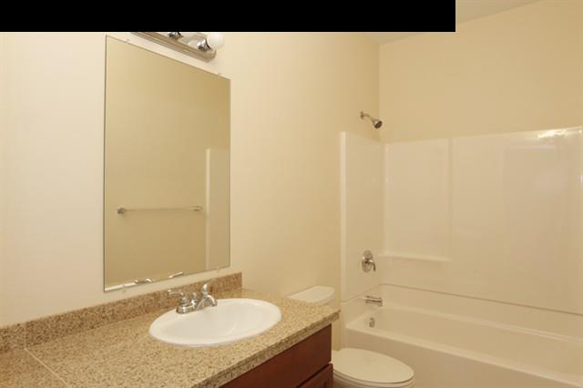 15 Maha Road, Unit 12 Makawao, HI 96768 - Photo 8 of 10 a bathroom with a granite countertop sink toilet and shower
