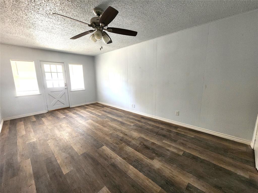 3604 Valley View Road Denton, TX 76209 - Photo 9 of 13 an empty room with windows and fan
