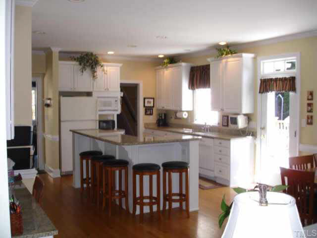 2708 Amstel Way Raleigh, NC 27613 - Photo 2 of 10 Fantastic open kitchen with granite counters, abundant cabinetry, large pantry (not shown), built-in desk and counter seating--as seen from family room Other