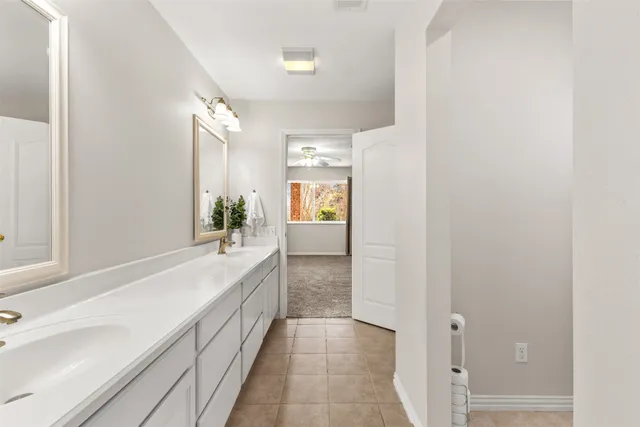 a large bathroom with a sink and a mirror